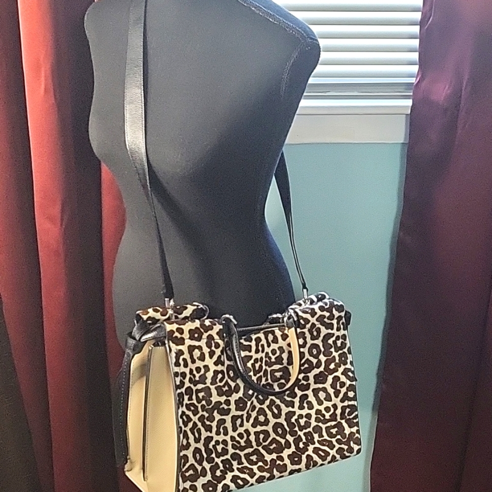 Calvin Klein animal print leather handbag with adjustable shoulder strap. Zipper